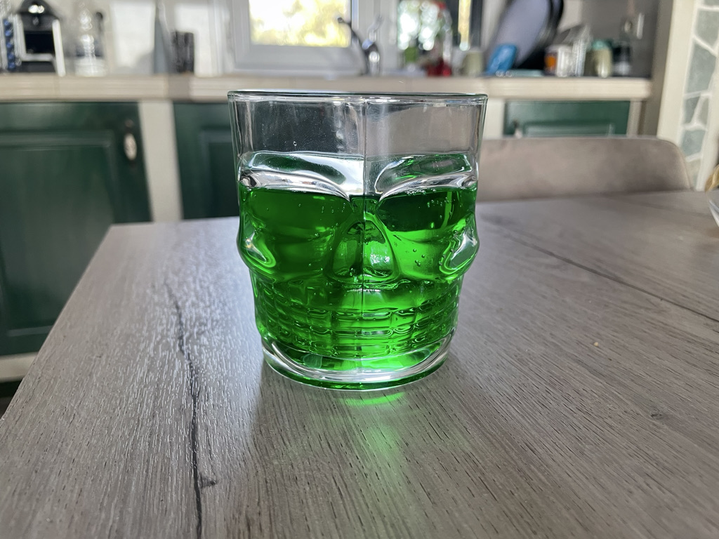 Green soda in a skull glass